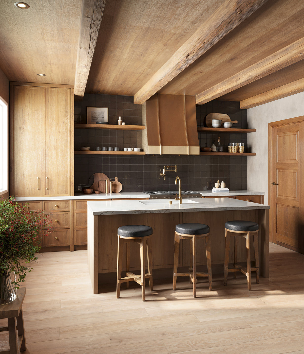 Rustic-modern kitchen with dark brown square tile backsplash, brass accents, wood beams, and a cozy island with barstools