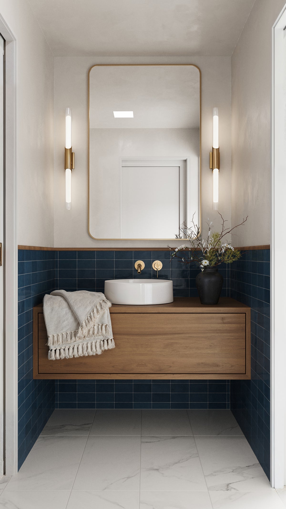 Modern powder room featuring glossy Mikayla cerulean-blue subway tiles, a floating wooden vanity, gold fixtures, and elegant vertical lighting