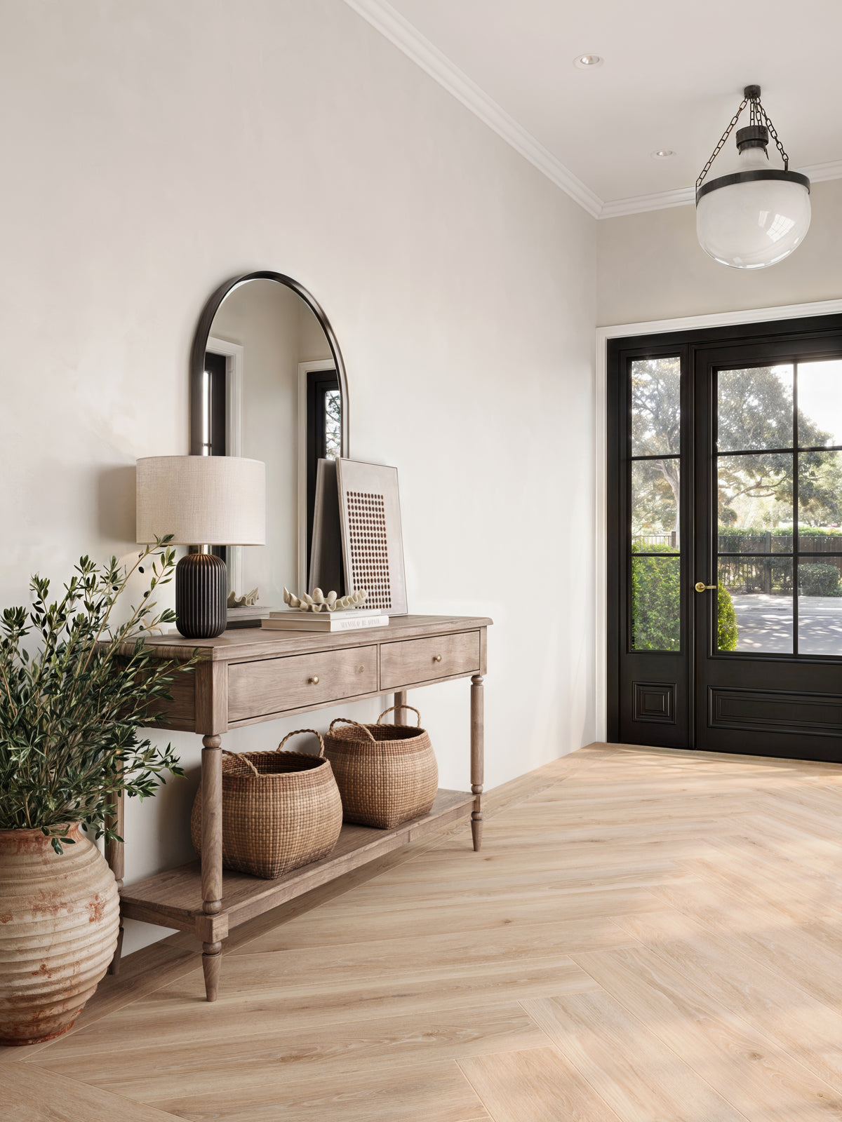 Warm and inviting, Jameson 8x48 matte porcelain tile in Camel features a herringbone layout with natural beige tones and wood-look grains, perfect for enhancing entryway elegance.
