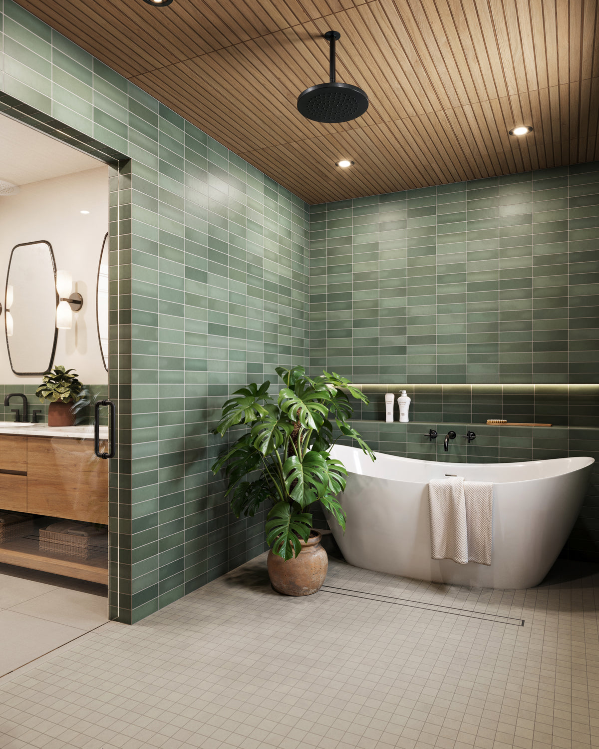 Modern bathroom featuring Ellie matte green subway tiles, a freestanding tub, wooden accents, and lush greenery for a serene spa-like ambiance