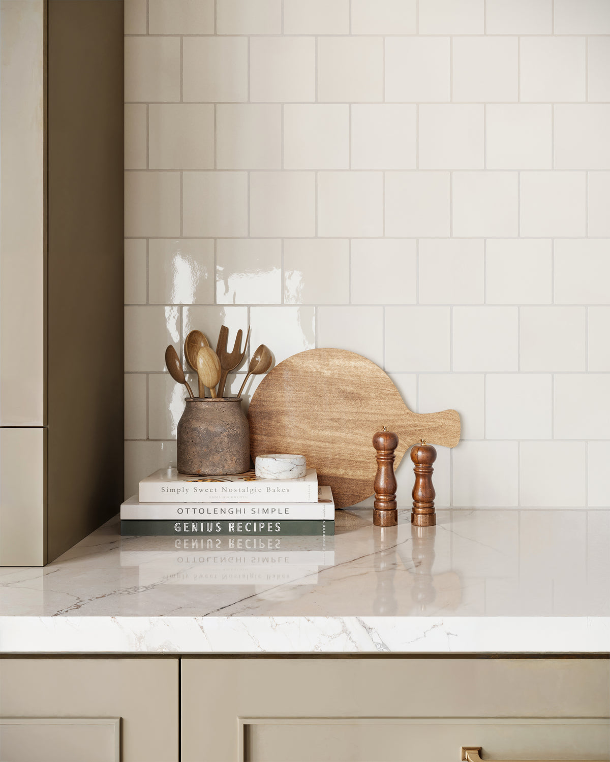 Kitchen backsplash featuring glossy 4x4 white tiles, paired with a marble countertop, natural wooden accents, and earthy decor