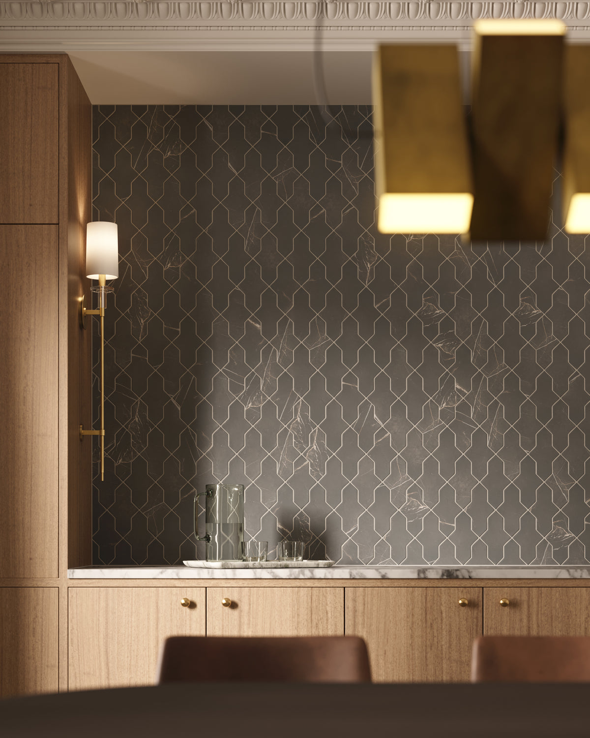 A wall of dark gray shield tiles adds subtle pattern behind wood cabinetry, working effortlessly with brass accents and warm lighting for a calm, layered look.