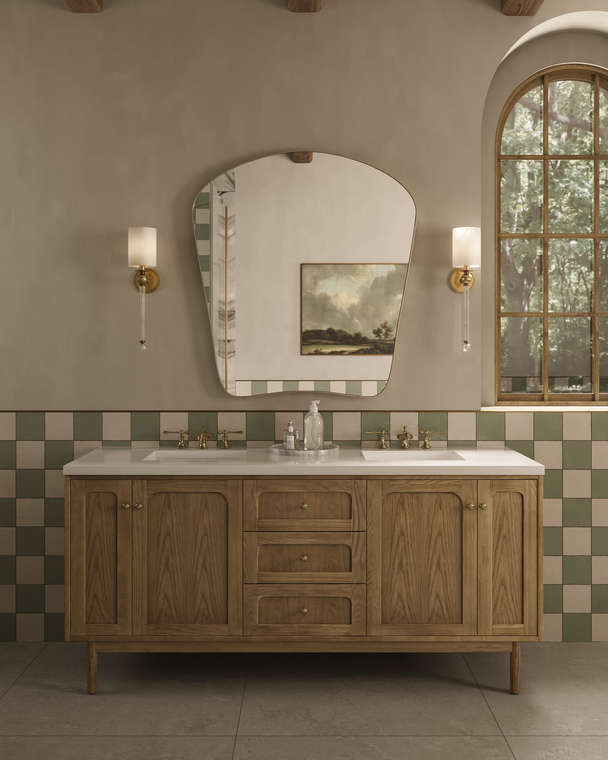 Bathroom with wood double vanity, large curved mirror, checker tile backsplash, and paired aged brass wall sconces with white shades.