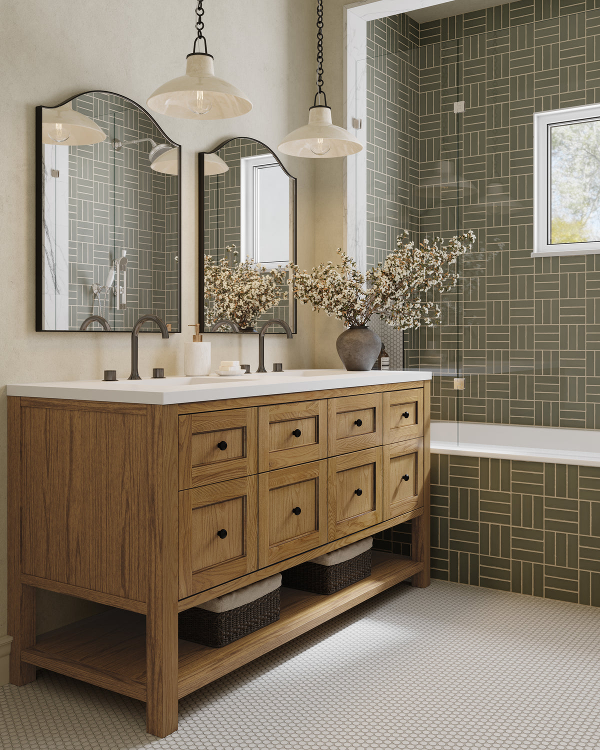 Bridgette 60" double vanity in Light Natural Oak with a white quartz countertop, featuring two undermount sinks, black faucets, multiple drawers, and an open lower shelf with woven baskets, styled with arched mirrors, pendant lights, and an olive geometric tile tub and shower surround.