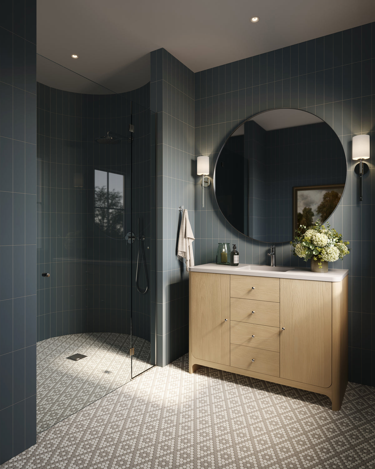 Modern bathroom with vertical subway tiles in earthy blue hue, a light wood vanity, round mirror, and patterned mosaic floor for a refined, spa-like feel.