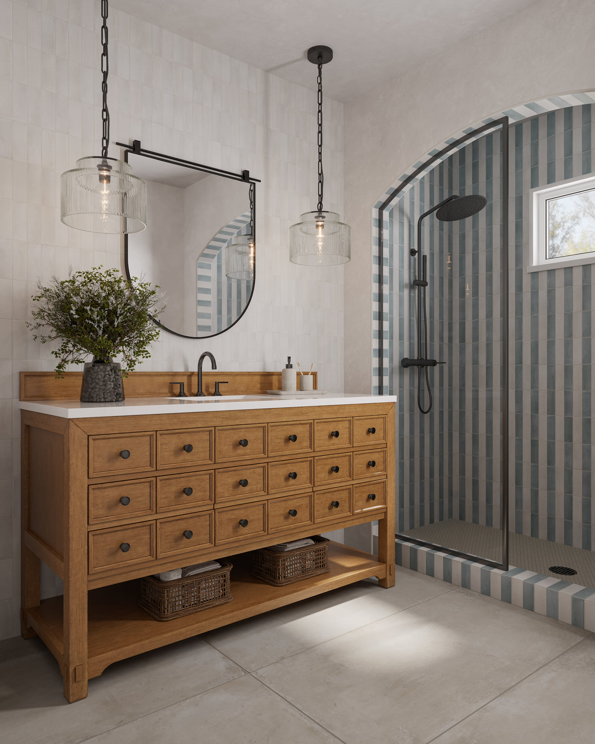 Rosalie 60-inch single vanity in amber birch with white Zeus quartz countertop, black faucet, round mirror, and pendant lights beside an arched striped tile shower.