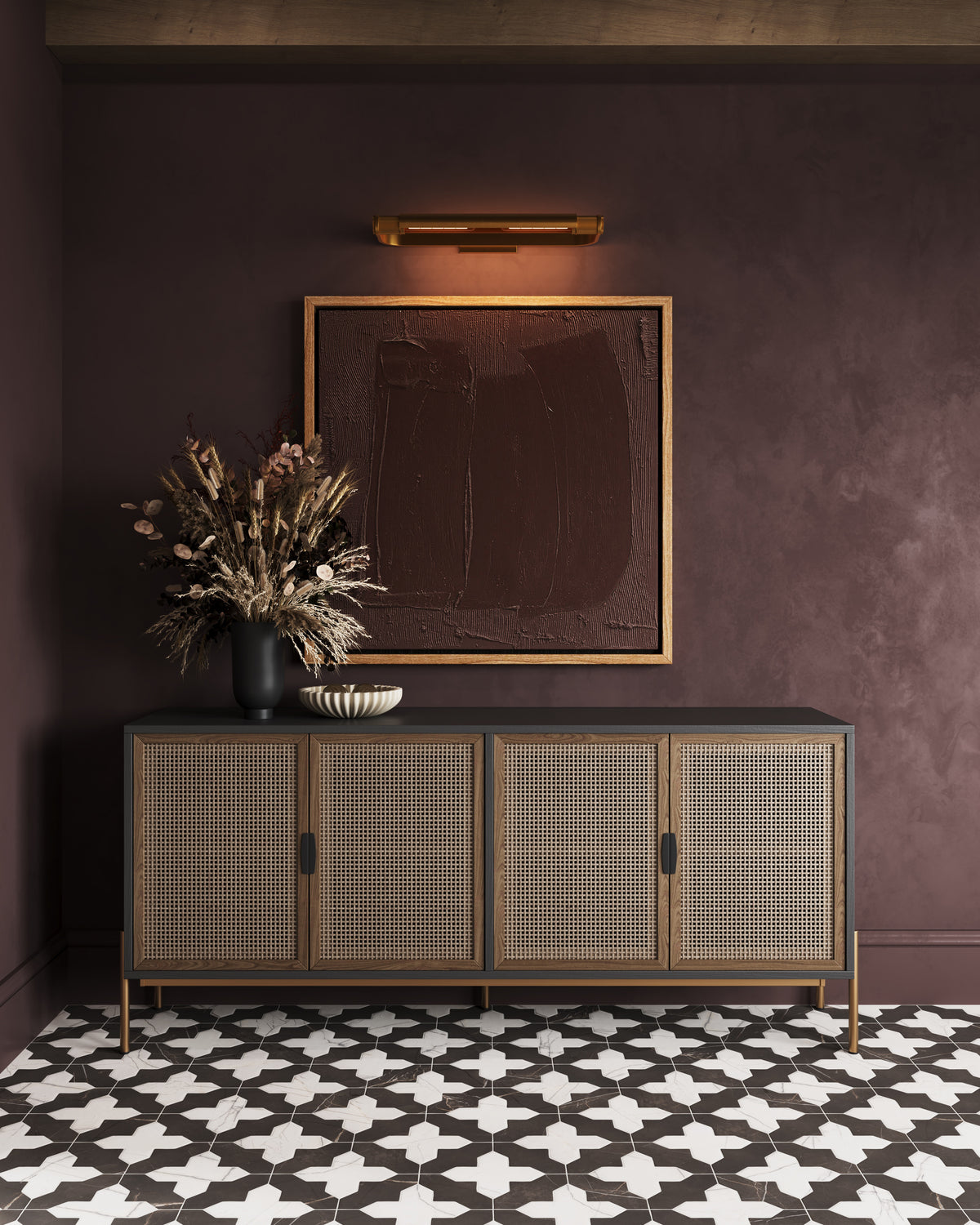 Black and white 8x8 star and cross tiles spread across the floor, grounding the room beneath woven wood cabinetry and warm lighting with a bold, graphic rhythm.