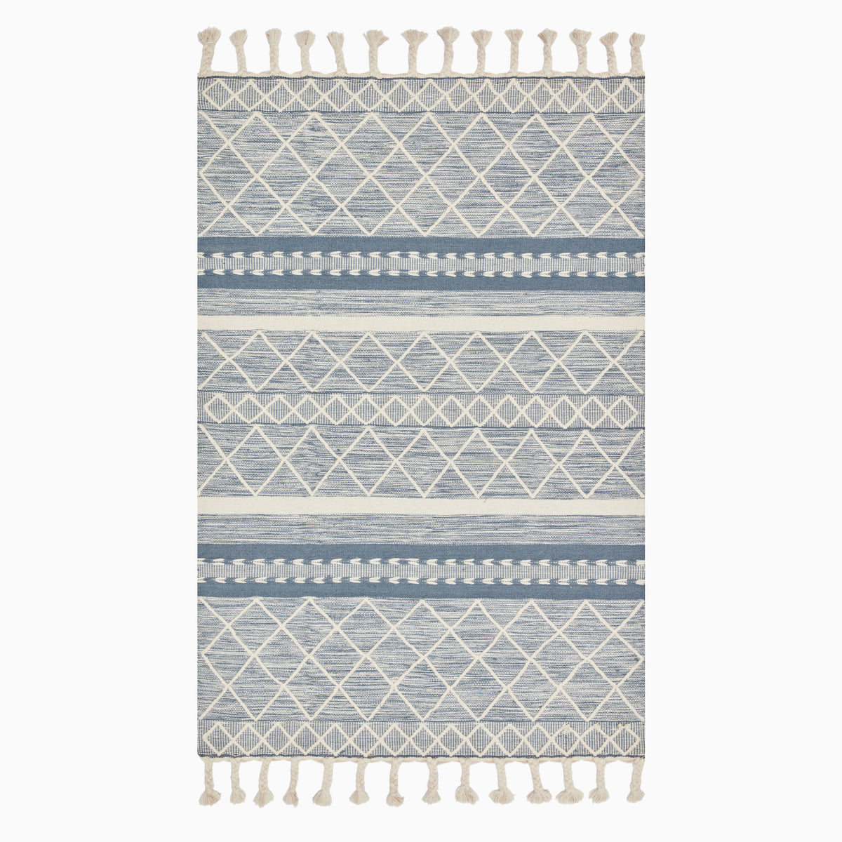 Hand loomed wool area rug, featuring intricate blue and ivory geometric patterns with tasseled edges, adding bohemian charm to any space.
