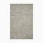 Made from a blend of wool and polyester, this handwoven rug has an ash-gray base with a plush looped texture, ideal for modern spaces.