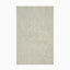 Hooked wool rug in soft aloe green, featuring a tonal border that adds texture and depth to transitional spaces.