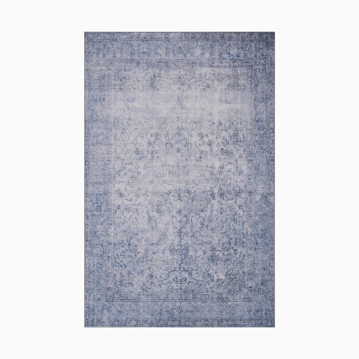 Power-loomed polyester face rug in indigo, featuring a distressed transitional design with intricate detailing for a timeless appeal.