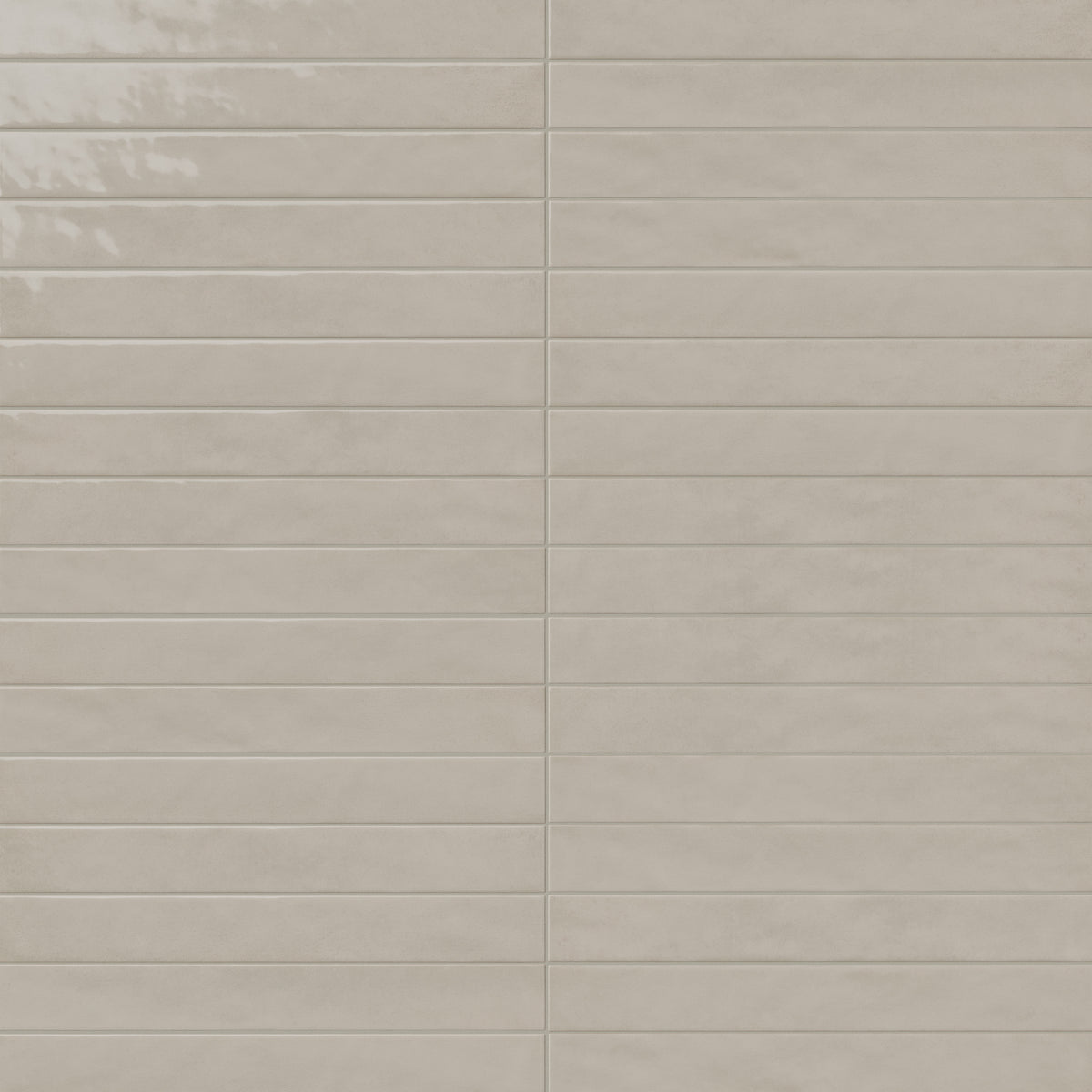 Glossy beige rectangular ceramic tiles with subtle tonal variation, smooth edges, and light grout lines in a stacked wall pattern.