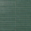 Green ribbed rectangular ceramic tiles with fine vertical grooves, glossy surface texture, and narrow grout lines in a stacked wall pattern.