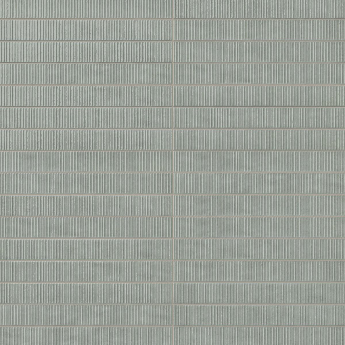 Pale green ribbed rectangular ceramic tiles with fine vertical texture, subtle tonal variation, and narrow grout lines in a stacked wall pattern.