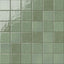 Glossy square tile in a muted jade green tone with handcrafted surface movement, softened edges, reflective glaze variation, and a clean grid layout.