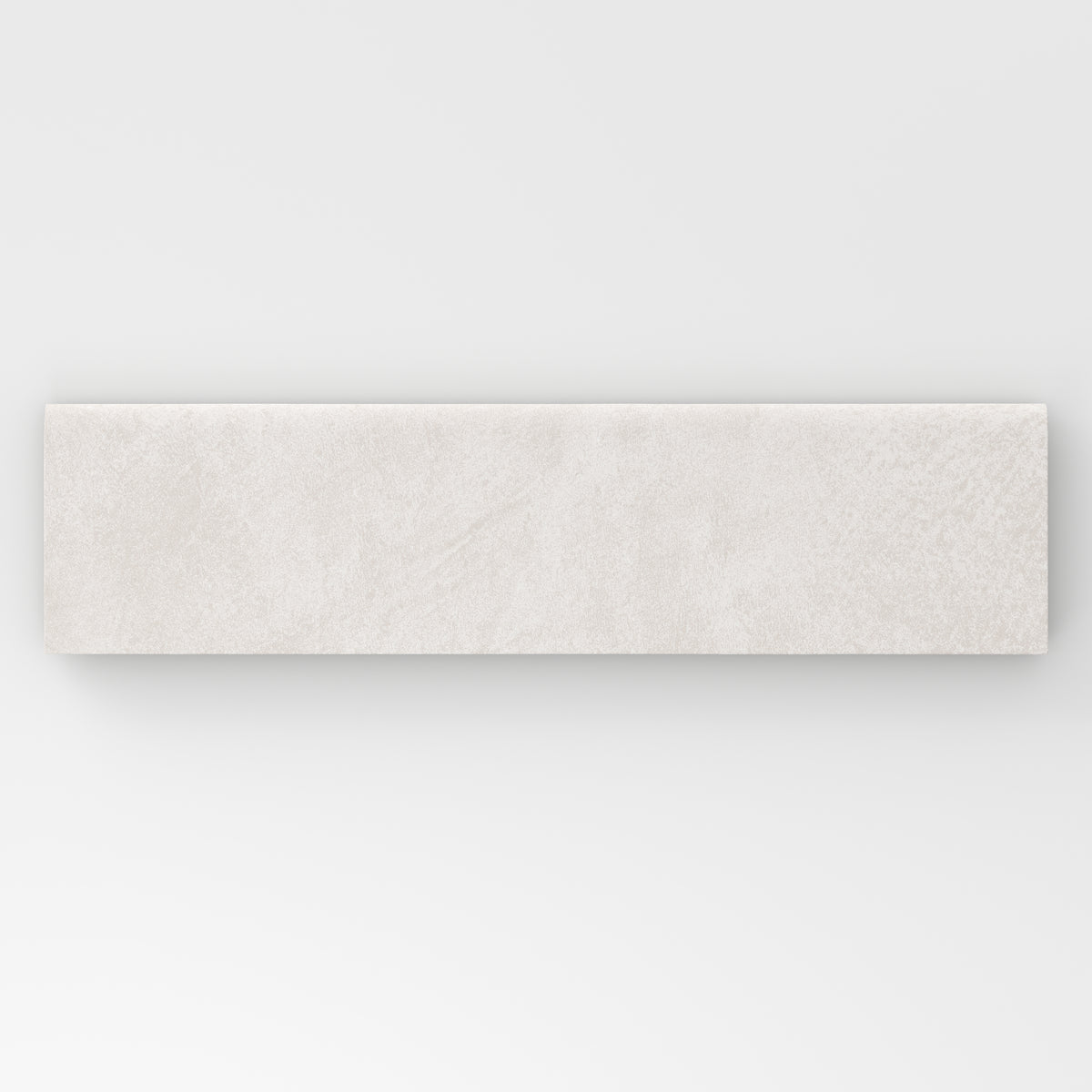 Rectangular bullnose porcelain tile in a matte finish with a smooth, lightly textured surface, featuring a light warm off-white color with subtle natural variation.