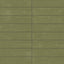 Earthy green 6x24 glossy porcelain tiles showcase subtle surface texture and layered color movement, bringing depth to the clean linear layout.