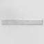 Elongated subway-style trim with a curved front edge, featuring a subtly textured surface and soft light gray tones.