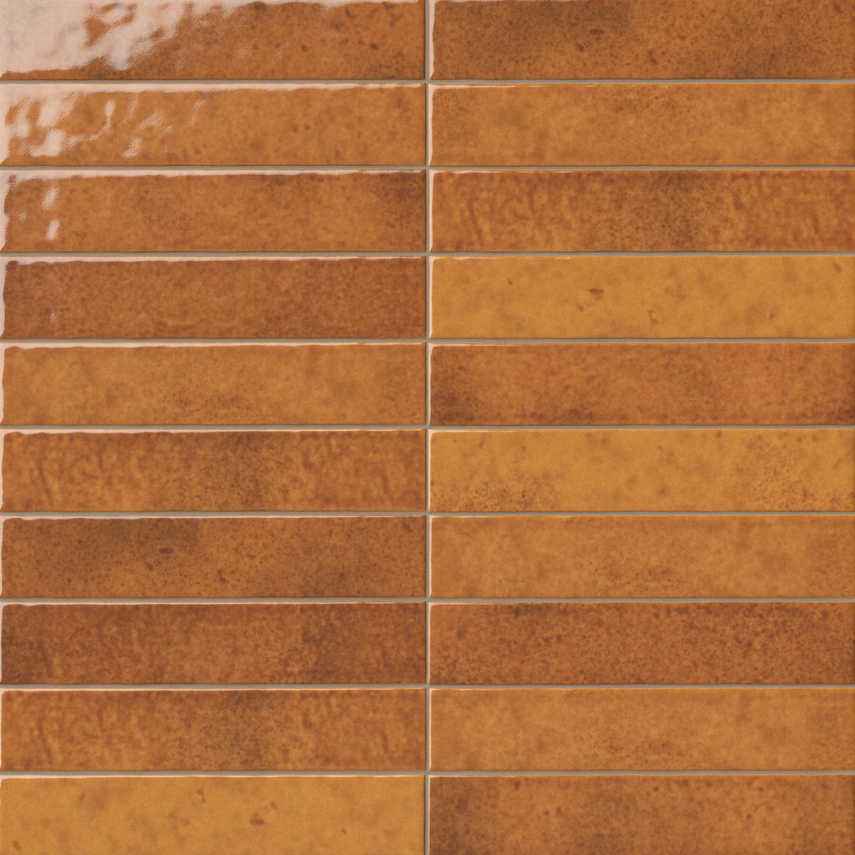 Brown 2x13 ceramic wall tiles with a handcrafted appearance, organic shading, and a glossy glazed finish that highlights the elongated format and subtle surface variation.