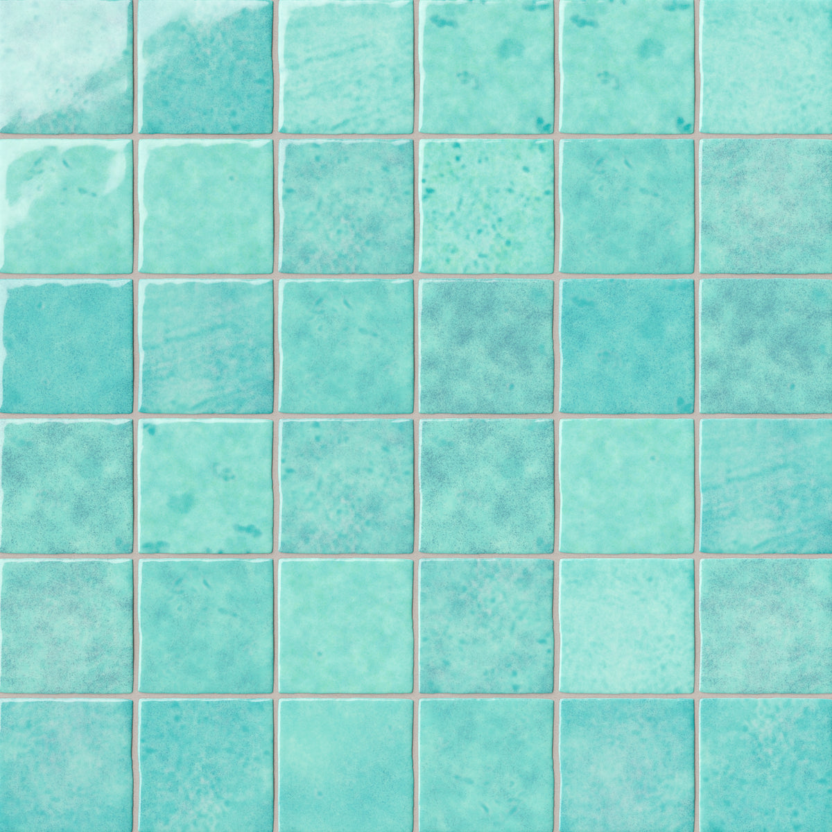 Grid of turquoise ceramic wall tiles showcasing layered color movement, a lustrous glazed finish, and subtle artisanal character across each 4x4 tile.