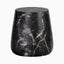 Bold white veining runs across the black tapered drum form of our Dante Outdoor End Table in Black, highlighting its natural marble-like surface detail.
