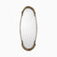 A slender oval mirror with chic arched detailing and an antique brass finish, featuring a warm, timeworn aluminum sheen that feels effortlessly romantic and Parisian.