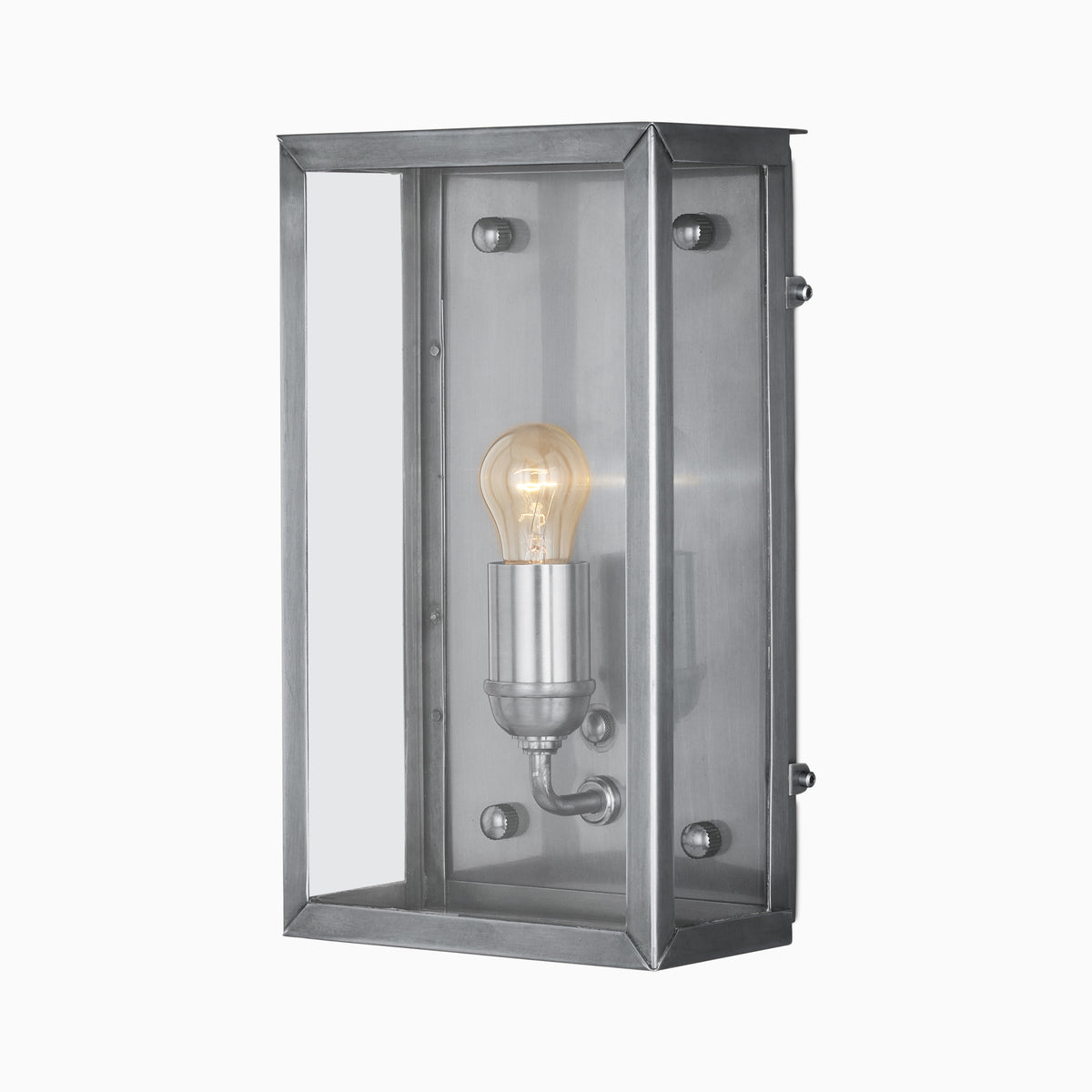 Brushed antique silver wall lantern with a beveled metal frame, clear glass panels, visible glowing bulb, and cool silver interior on a plain white background.