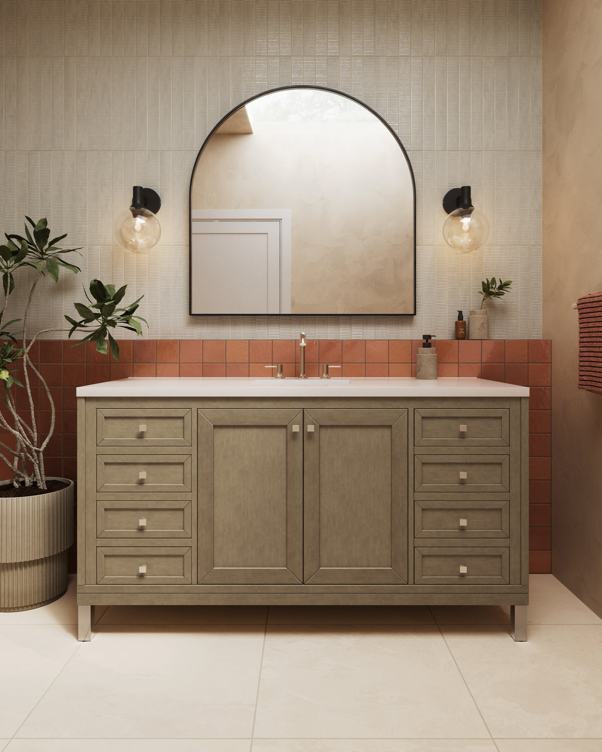 Set against terracotta tile wainscoting and textured beige wall tiles, the Janelle 60 inch single vanity in Walnut Whisper features warm wood cabinetry and a White Zeus Silestone top.