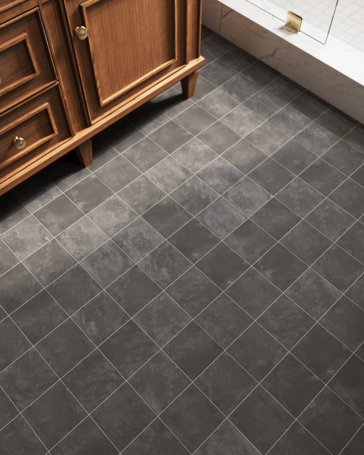 Matte charcoal porcelain floor tiles with natural stone variation, adding depth and visual softness to this bathroom floor while pairing seamlessly with classic wood vanity details.