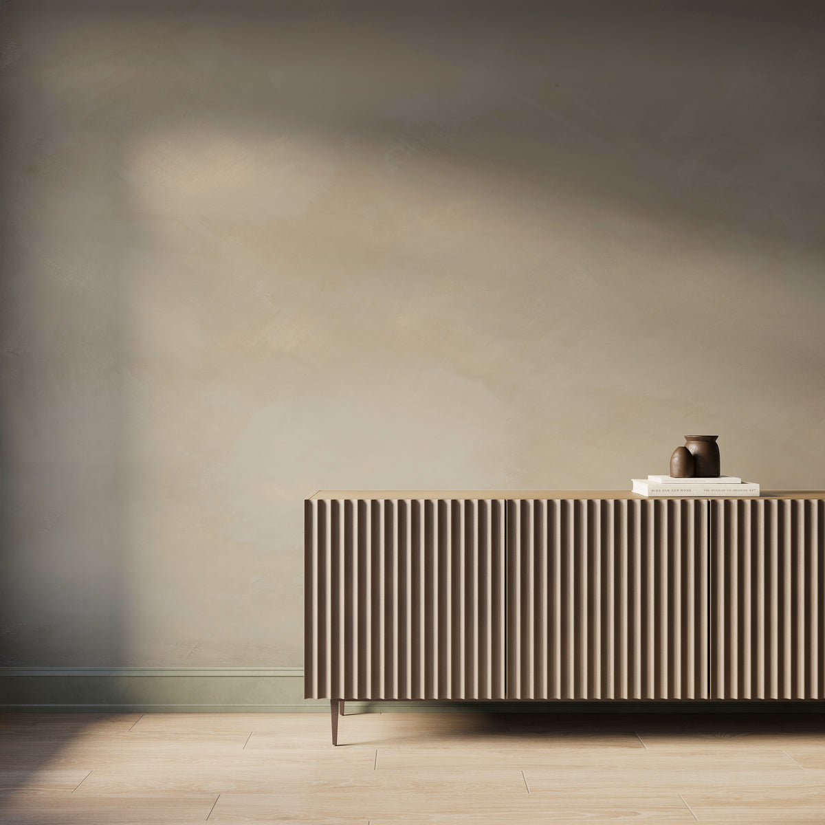 Panoramic green abstract limewash-look wallpaper mural with soft tonal texture, styled behind a modern fluted wood console.