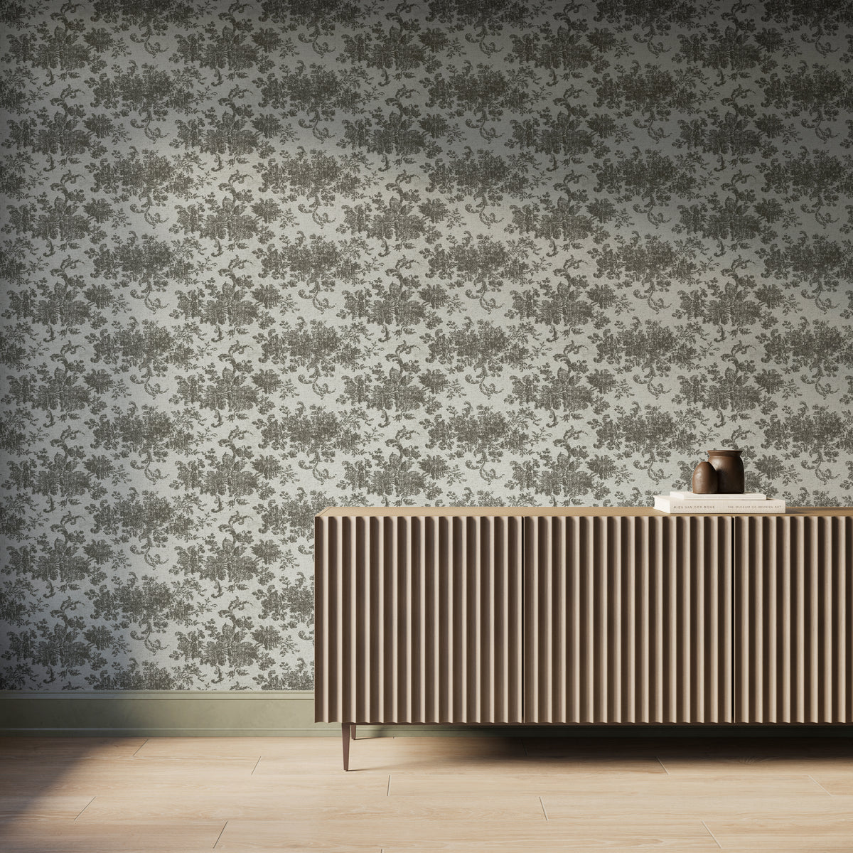 Interior scene featuring Brocade Wallpaper in Olive II with an olive green damask floral motif over a matte off-white background, styled with a fluted wood console cabinet, decorative books and vases, and light wood flooring with soft natural light.