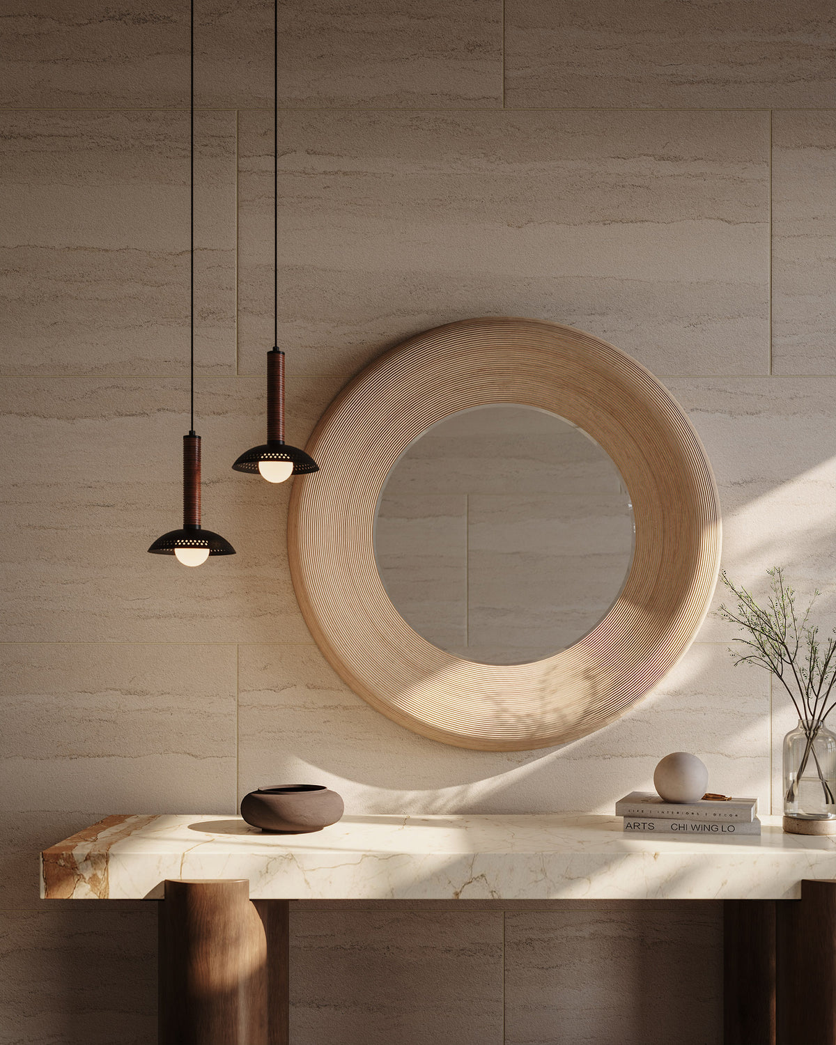 Meliora round mirror in cream bamboo with concentric grooves, styled above a marble console with pendant lights and warm natural textures.