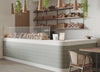 Soft sage subway tiles set a calming tone in a cozy artisan bakery, where natural wood and warm lighting invite relaxed indulgence.